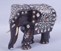 A LARGE INDIAN HARDWOOD AND INLAID MODEL ELEPHANT, inlaid with exotic timber and bone, 21cm high,