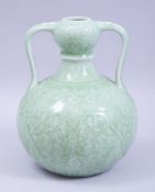 A CHINESE CELADON TWIN HANDLED PORCELAIN VASE, decorated with lotus, six character mark to base,