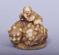 A JAPANESE MEIJI PERIOD CARVED IVORY NETSUKE - BOY UPON SHI SHI, a young boy on the back of a shi