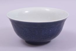 A CHINESE BLUE GLAZE PORCELAIN BOWL, with incised underglaze decoration, the base with six character