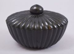 AN INDIAN JADE OVAL SHAPED BOX AND COVER, with ribbed exterior, 12.5cm wide.