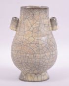 A CHINESE CRACKLE GLAZE TWIN HANDLE VASE, 17cm high.