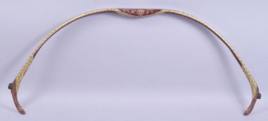 A TURKISH OTTOMAN PAINTED WOODEN BOW, decorated with foliate design and gilt highlights, 81cm wide.