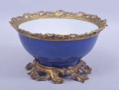 A CHINESE BLUE GLAZED BOWL WITH ORMOLU MOUNTS, with gilded mount to the rim and raised on a