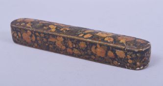 A 19TH CENTURY PERSIAN QAJAR LACQUERED PAPIER MACHE QALAMDAN PEN BOX, with floral decoration, 23.5cm