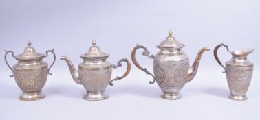 A GOOD PERSIAN WHITE METAL FOUR PIECE TEA SET, the body of each with panels of flora, each with part