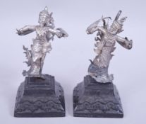 A PAIR OF 19TH CENTURY BURMESE SILVER MODELS OF DANCERS, both figures mounted to carved hardwood