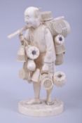 A LARGE JAPANESE MEIJI PERIOD CARVED IVORY OKIMONO - BASKET SELLER, the man holding a length of