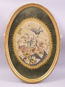 A CHINESE OVAL SILK WORK PICTURE, embroidered with a floral bouquet, framed and glazed, overall 55cm