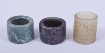 THREE CHINESE ARCHER'S RINGS, one jade, the other two hardstone, (3).