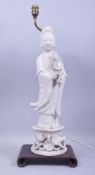 A LARGE BLANC DE CHINE PORCELAIN FIGURAL LAMP, the figure mounted to a hardwood base with lamp