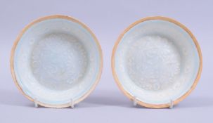 A PAIR OF CHINESE CELADON GLAZED POTTERY BOWLS, the interior decorated with incised underglaze