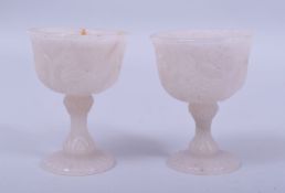 A PAIR OF INDIAN MUGHAL CARVED JADE STEM CUPS, carved with birds and flora, 7.5cm high.