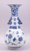 A CHINESE BLUE AND WHITE TWIN HANDLE PORCELAIN BOTTLE VASE, decorated with stylised flora, 27.5cm