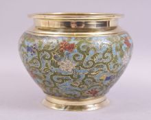 A CHINESE CHAMPLEVE ENAMEL BRASS BOWL, decorated with floral design, 15cm diameter.