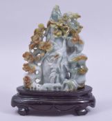 A 20TH CENTURY CHINESE CARVED JADE / JADEITE NATURALISTIC GROUP, mounted to a wooden base, 20cm
