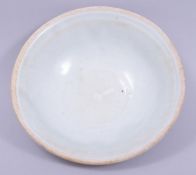A CHINESE CELADON PARTLY GLAZED POTTERY BOWL, 15.5cm diameter.