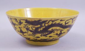 A CHINESE YELLOW GROUND PORCELAIN BOWL, the exterior decorated with dragons and the flaming pearl of