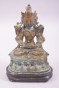 A CHINESE BRONZE FIGURE OF A DEITY, fixed to a wood stand, 14cm high.