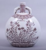 A CHINESE MING STYLE UNDERGLAZE RED TWIN HANDLE MOONFLASK, the body decorated with peony, six