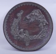 A LARGE AND HEAVY JAPANESE BRONZE CHARGER, with a relief depiction of a sennin below a tree with a