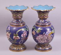 A PAIR OF CHINESE CLOISONNE VASES - with a deep royal blue ground depicting native flora and