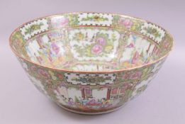 A LARGE CHINESE CANTON PORCELAIN PUNCH BOWL, painted with panels of figures, birds and native flora,