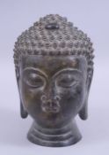 A BRONZE SHAKYAMUNI BUDDHA HEAD, 19.5cm high.