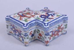 A CHINESE MING STYLE WUCAI OCTAGONAL FORM PORCELAIN BOX AND COVER, decorated with dragons, with