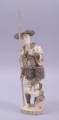 A JAPANESE LATE MEIJI CARVED IVORY OKIMONO - FISHERMAN, stood aside his young holding a pipe and
