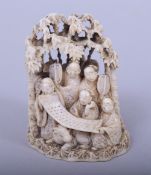 A JAPANESE MEIJI PERIOD CARVED IVORY OKIMONO - NINE IMMORTALS under bamboo trees holding a scroll