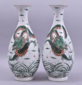 A PAIR OF CHINESE FAMILLE VERTE PORCELAIN VASES, the body of each painted with a dragon and the