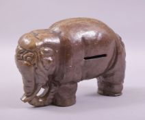 A SALT GLAZED TERRACOTTA ELEPHANT MONEY BOX, 22cm long.