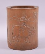 A CHINESER BAMBOO BRUSH POT, carved with a young boy on a water buffalo, 15.5cm high.