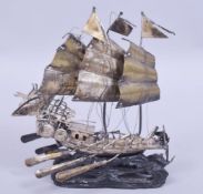 A CHINESE SILVER MODEL OF A JUNK / SHIP, fixed to wooden wave form base, the back of the ship with a