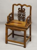 A CHINESE PIERCED AND CARVED WOODEN CHAIR, with shaped top rail and carved back section with a bat