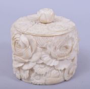 A JAPANESE MEIJI PERIOD CARVED IVORY BOX AND COVER, carved with chrysanthemum, 9.5cm high.
