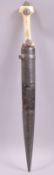 A 19TH CENTURY OTTOMAN KINDJAL WITH WALRUS IVORY GRIP, the 30cm tapering blade etched and dated