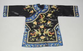 A GOOD CHINESE BLACK SILK ROBE, colourfully embroidered with exotic birds and flowers.