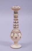 A 19TH CENTURY INDIAN CARVED AND STAINED PEPPER SHAKER, 10.5cm high.