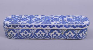 A TURKISH KUTAHYA POTTERY PEN BOX, containing two compartments and inkwell, 28.5cm long.