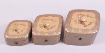 A GRADUATED SET OF THREE JAPANESE SHIBIYAMA DECORATED LACQUER BOXES, diamond shaped, each with