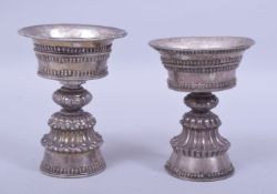 TWO TIBETAN WHITE METAL CUPS - possibly silver, 12cm and 11cm.