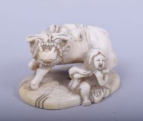 A JAPANESE MEIJI PERIOD CARVED IVORY NETSUKE - OXEN AND FEMALE, the female figure seated aside an