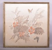 A CHINESE SILK WORK EMBROIDERD PICTURE depicting birds and butterflies amongst flora, 53cm x 53cm.