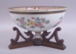 A CHINESE FAMILLE ROSE PORCELAIN BOWL OR LARGE COVER on a wooden stand, painted with sprays of