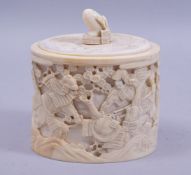 A JAPANESE MEIJI PERIOD CARVED IVORY LIDDED BOX, decorated with samurai warrior scenes of battle,