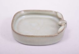 A CHINESE CELADON GLAZE BRUSH WASHER, the base with incised calligrpahy, 10cm wide.