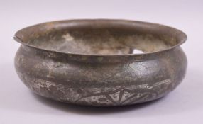 A 17TH CENTURY ISLAMIC SILVER INLAID COPPER CIRCULAR BOWL, with floral inlay and calligraphic