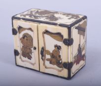 A JAPANESE MEIJI PERIOD CARVED IVORY MINIATURE CABINET, with lacquer decoration of figures and